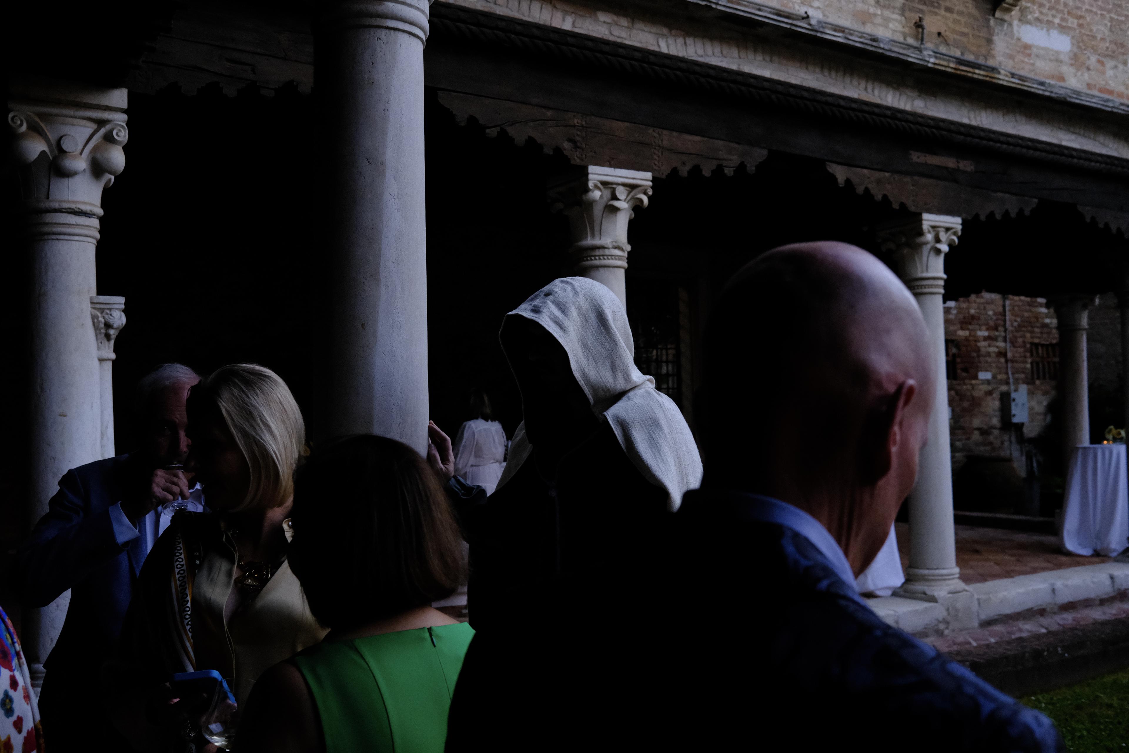 Mysterious figure wearing a cloak of masks